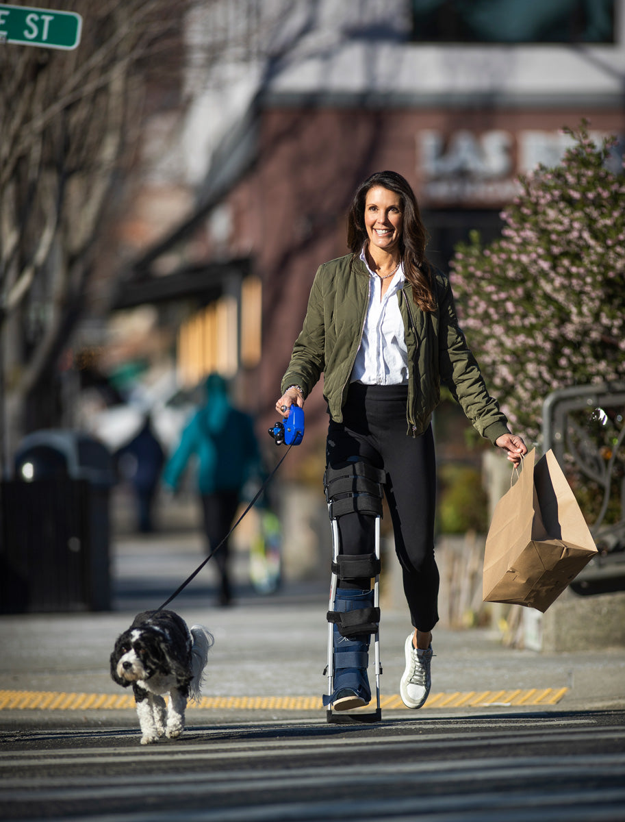 woman walking her dog with her hands free crutch freedomleg